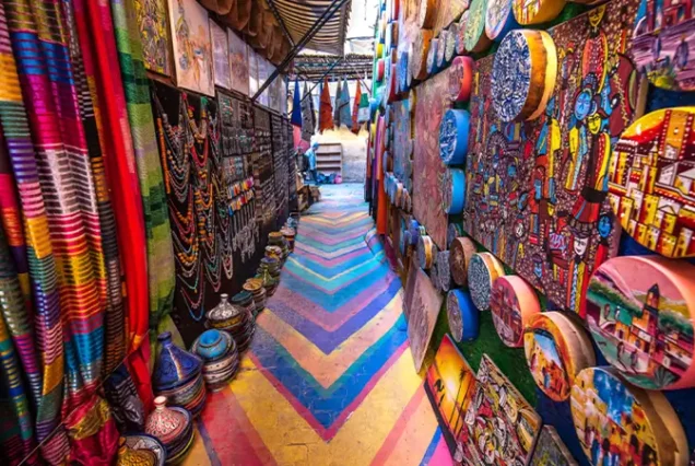 Colorful handmade decorative plates with intricate patterns on display in the local market of Fes’s old medina.